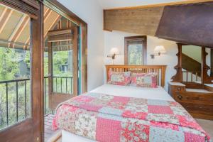 a bedroom with a bed and a balcony at Manitou Lodge 7 by Alpine Lodging Telluride in Telluride