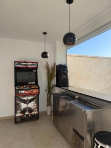 a room with a counter with a video game at Chalet Escapada in Seville