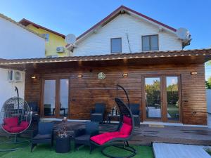 a house with a patio with chairs and a swing at La samba in Crisan