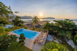 an outdoor pool with a view of the beach at Hortensia Luxury Beach Villa in Chaloklum