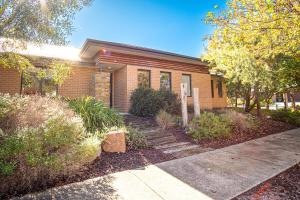 a brick house with stairs in front of it at Amaroo in Bright