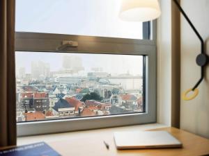 a window with a view of a city at Ibis Den Haag City Center in The Hague