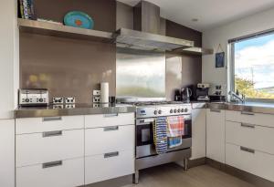 a kitchen with white cabinets and a stove at Paradise at Palm Beach in Palm Beach