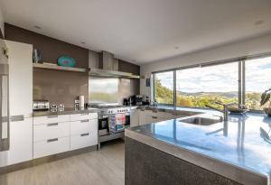 a kitchen with a counter and a large window at Paradise at Palm Beach in Palm Beach