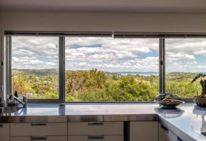 a kitchen with a large window with a view at Paradise at Palm Beach in Palm Beach +33 photos