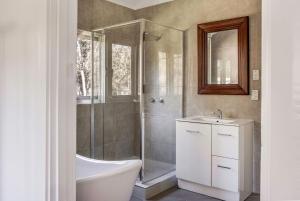 a bathroom with a shower and a tub and a sink at Lockn Heart Homestead in Quindalup +23 photos