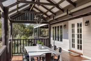 a patio with a table and chairs on a deck at Lockn Heart Homestead in Quindalup