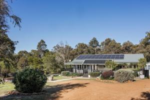 a house with solar panels on the roof at Lockn Heart Homestead in Quindalup