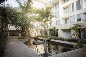 a building with a pond in front of a building at Sheraton Jakarta Soekarno Hatta Airport in Tangerang