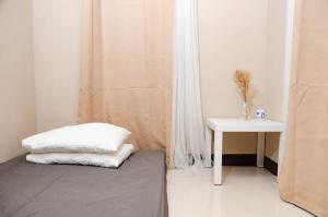 a bedroom with a bed and a side table at Casa Lumina in Tinuric
