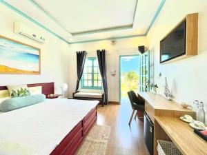 a room with a bed and a desk and a tv at Phan rang kite center in Ấp Mỹ Hải +86 photos