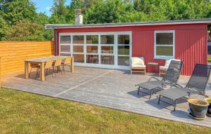a deck with a table and chairs and a building at 2 Bedroom Stunning Home In Vordingborg in Vordingborg