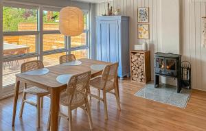 a dining room with a table and chairs and a wood stove at 2 Bedroom Stunning Home In Vordingborg in Vordingborg