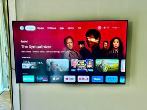 a flat screen tv hanging on a wall at Beautiful Brighton in Melbourne