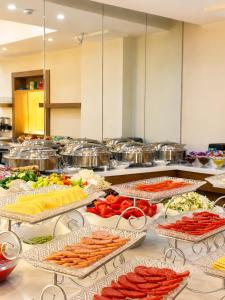a buffet line with many different types of food at Firdavsi Hotel in Dushanbe