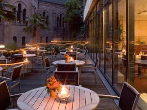 a row of tables and chairs on a patio at Mercure Hotel Plaza Essen in Essen