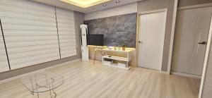 a bathroom with a sink and a tv on a wall at 뷰하우스 in Jeonju +31 photos