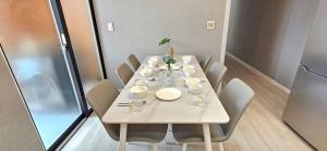 a table in a room with chairs and a white table at 뷰하우스 in Jeonju