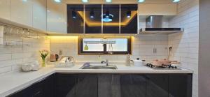 a kitchen with a sink and a stove at 뷰하우스 in Jeonju
