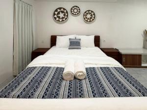 a bedroom with a large bed with towels on it at The Lavana Pondok JegegBagus near Pandawa Beach in Ungasan +33 photos