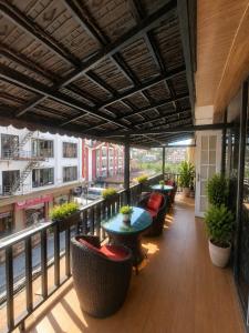 a patio with tables and chairs on a balcony at Việt Anh Hotel in Sapa
