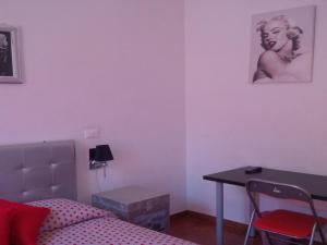 a bedroom with a bed and a desk and a table at Magic Stefy's Rooms in Rome