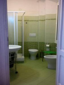 a bathroom with a toilet and a bidet and a sink at Magic Stefy's Rooms in Rome