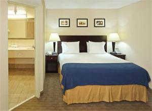 a hotel room with a bed and a bathroom at Holiday Inn Express Little Rock-Airport, an IHG Hotel in Little Rock
