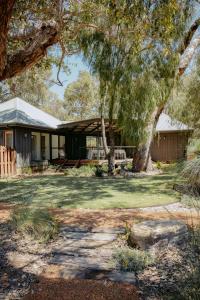 a house with a tree in the yard at Yala Yallingup Retreat & Spa in Dunsborough