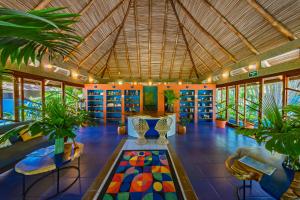 a large room with a table and chairs and plants at Xandari Resort & Spa in Alajuela