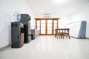 a kitchen with two refrigerators and a table and chairs at Awana Town House 40 in Timuran