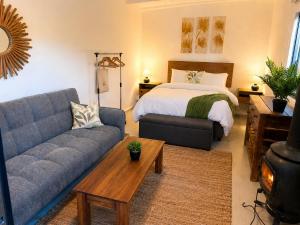 a living room with a couch and a bed at Kaaimans River Rustic Views in Wilderness