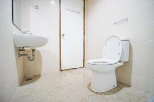a bathroom with a toilet and a sink at Awana Town House 40 in Timuran +28 photos