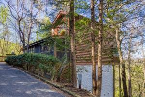 a house with a fence in front of it at Barefoot Dreams in Sevierville