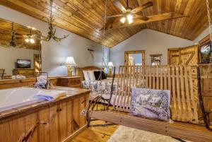 a bedroom with a crib and a tub in a room at Barefoot Dreams in Sevierville