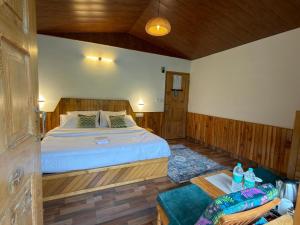 a bedroom with a large bed in a room at Enroot Manali in Vashisht
