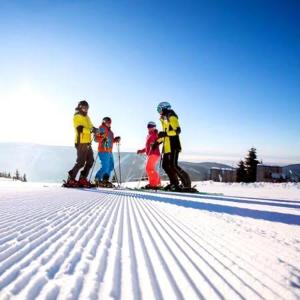 a group of people on skis in the snow at All Seasons Mansfield in Mansfield