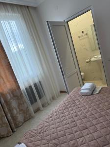 a bedroom with a mirror and a pink bed at Guest House MD 2 in Tatʼev +53 photos