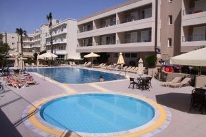 a large swimming pool in front of a building at Agela Hotel & Apartments in Kos