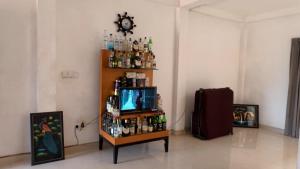 a room with a tv and a shelf with alcohol at Iris Grand Hotel in Nittambuwa +16 photos