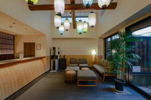 a lobby with a waiting room with a couch and a bar at シーザー祇園CaesarGion in Kyoto