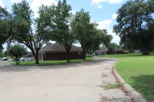 a dirt road leading to a house with trees at Bent Tree Motel in Emory