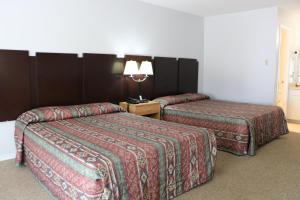 Postel nebo postele na pokoji v ubytování Bent Tree Motel