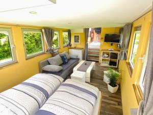 a caravan living room with a couch and a tv at Black Pearl in Pölitz