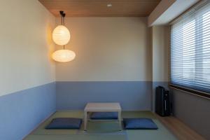 a room with a table and two blue mats at シーザー祇園CaesarGion in Kyoto