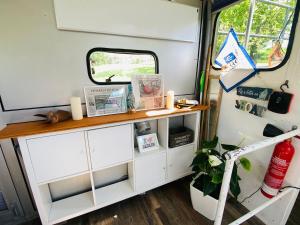 a white cabinet with a table in a camper at Black Pearl in Pölitz