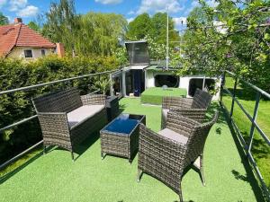 a patio with wicker chairs and a table at Black Pearl in Pölitz