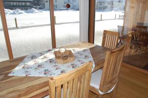 a dining room table with a napkin and a basket on it at Appartements Christine in Bezau