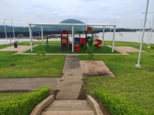 a playground in a park next to the water at Hermosa casa con piscina in Sitio del Niño