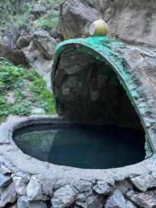 a small pool of water in a stone wall at Alim yurt camp in Mineralʼnyy Istochnik Altyn-Arasan +6 photos